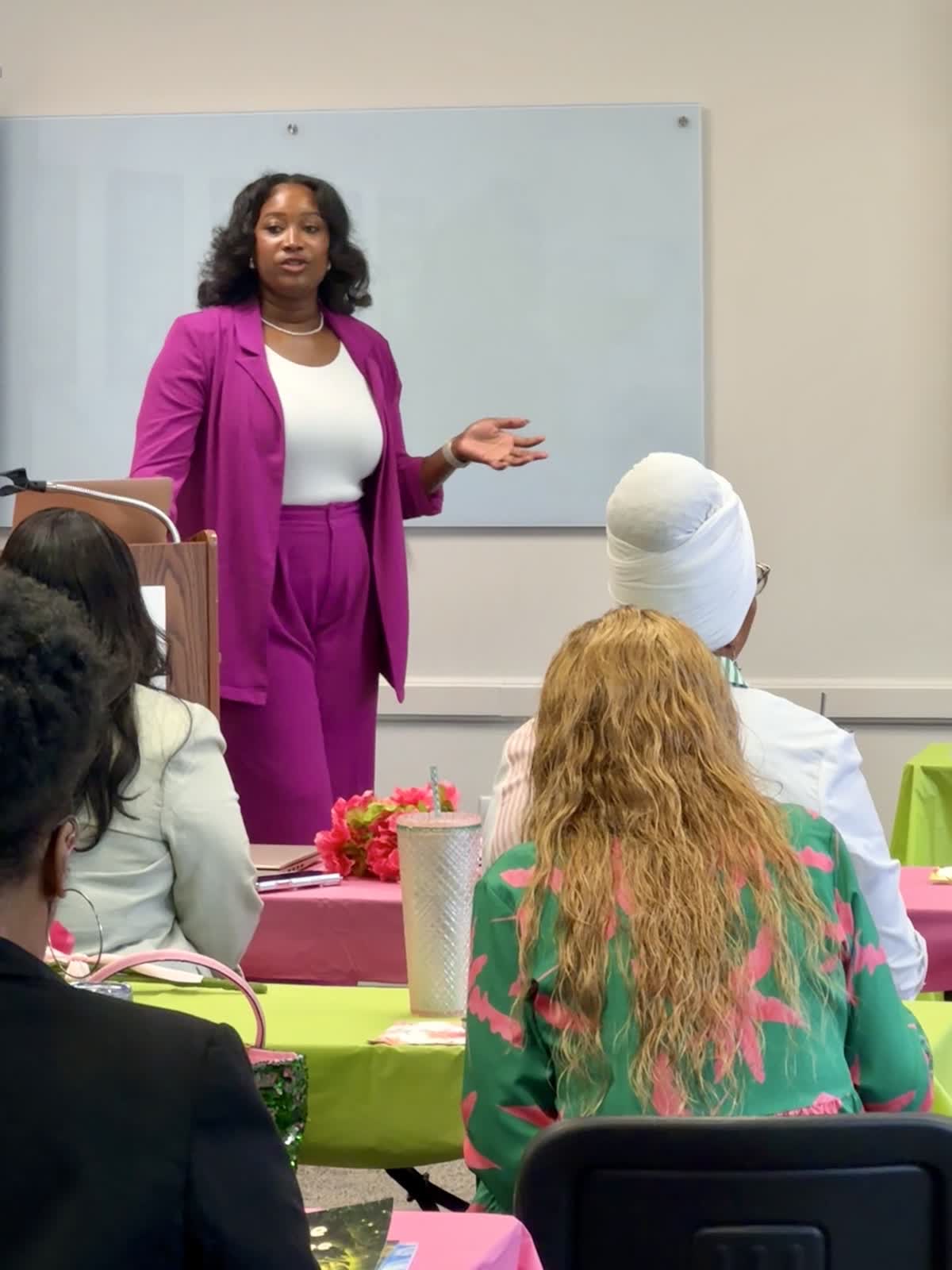 Dr. Jess speaking to a room at a professional event